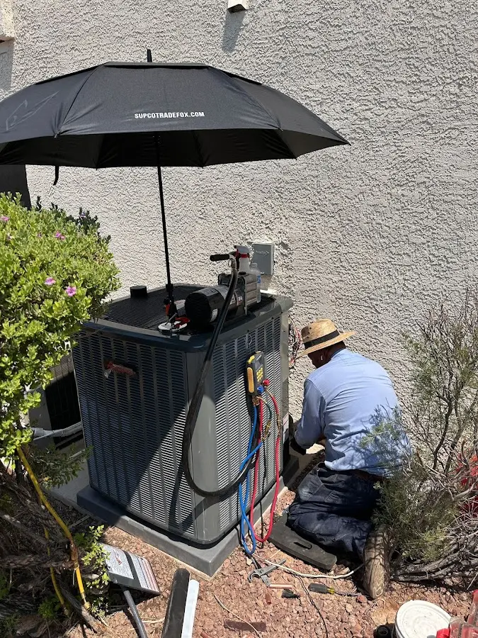 HVAC technician performing outdoor AC maintenance in Walled Lake