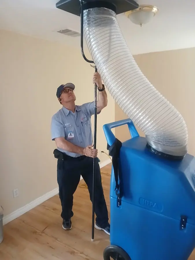 Furnace Tune-Up technician using HEPA equipment in Walled Lake